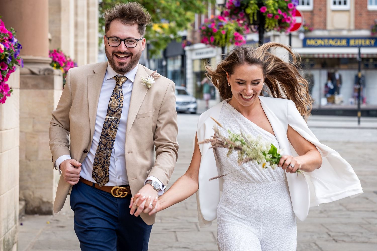 Newlyweds running towards the camera in London