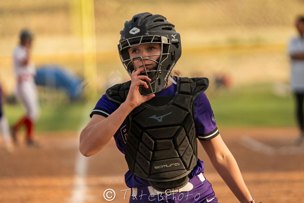 Girls softball player unmasking herself