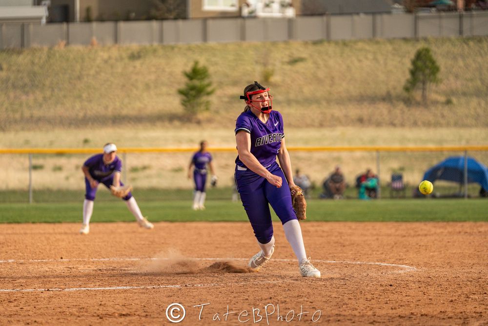 Girls softball player pitching the softball