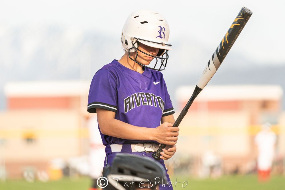 Girls softball player focused on her bat