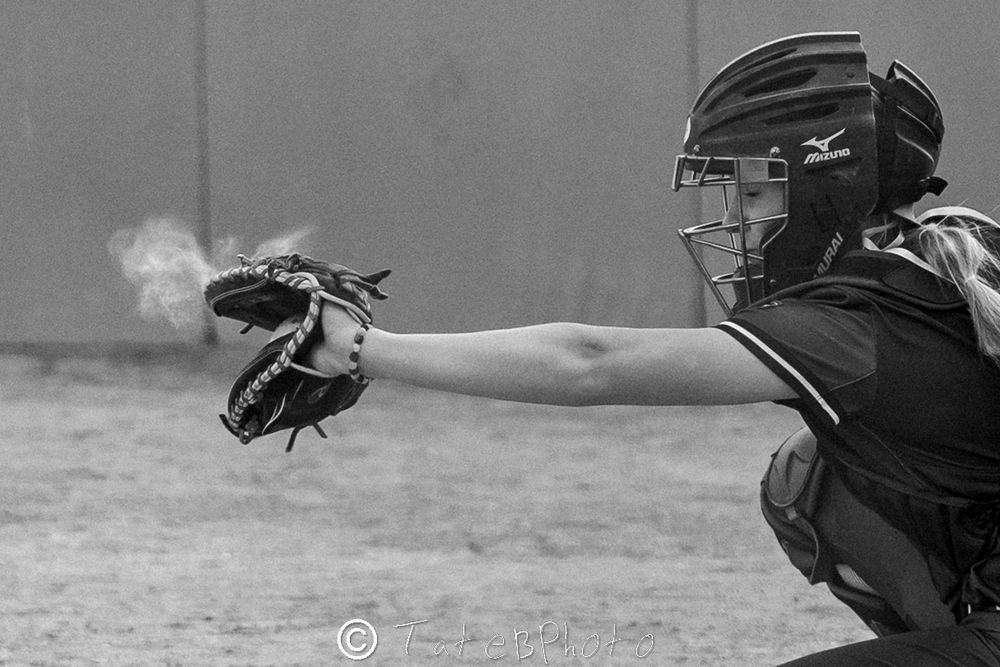 Girls softball player catching a softball