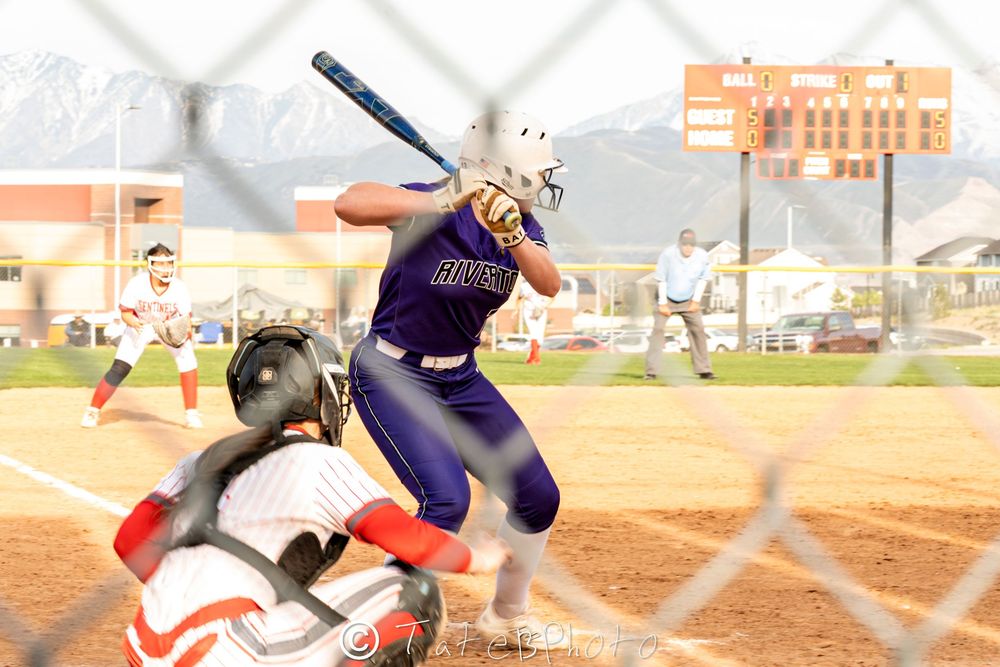 Girls softball player mid swing