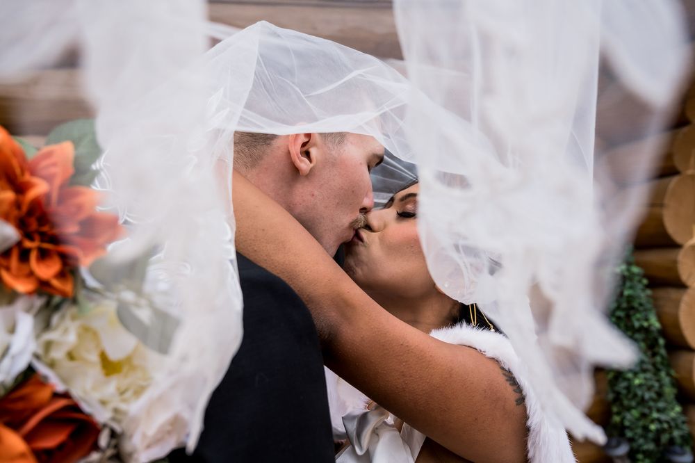 A close-up view of a bride's veil blowing in the wind during a wedding ceremony.