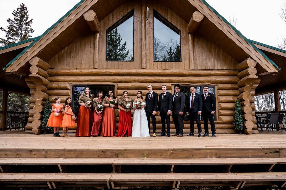 A rustic log cabin wedding venue with wooden beams and natural forest surroundings in winter.