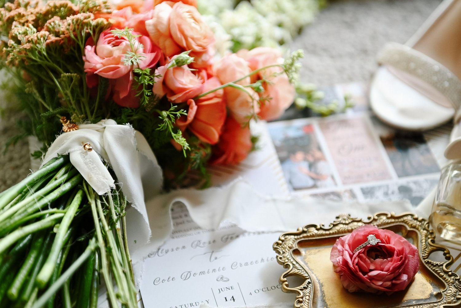 A romantic arrangement of coral peonies with wedding stationery and vintage details.