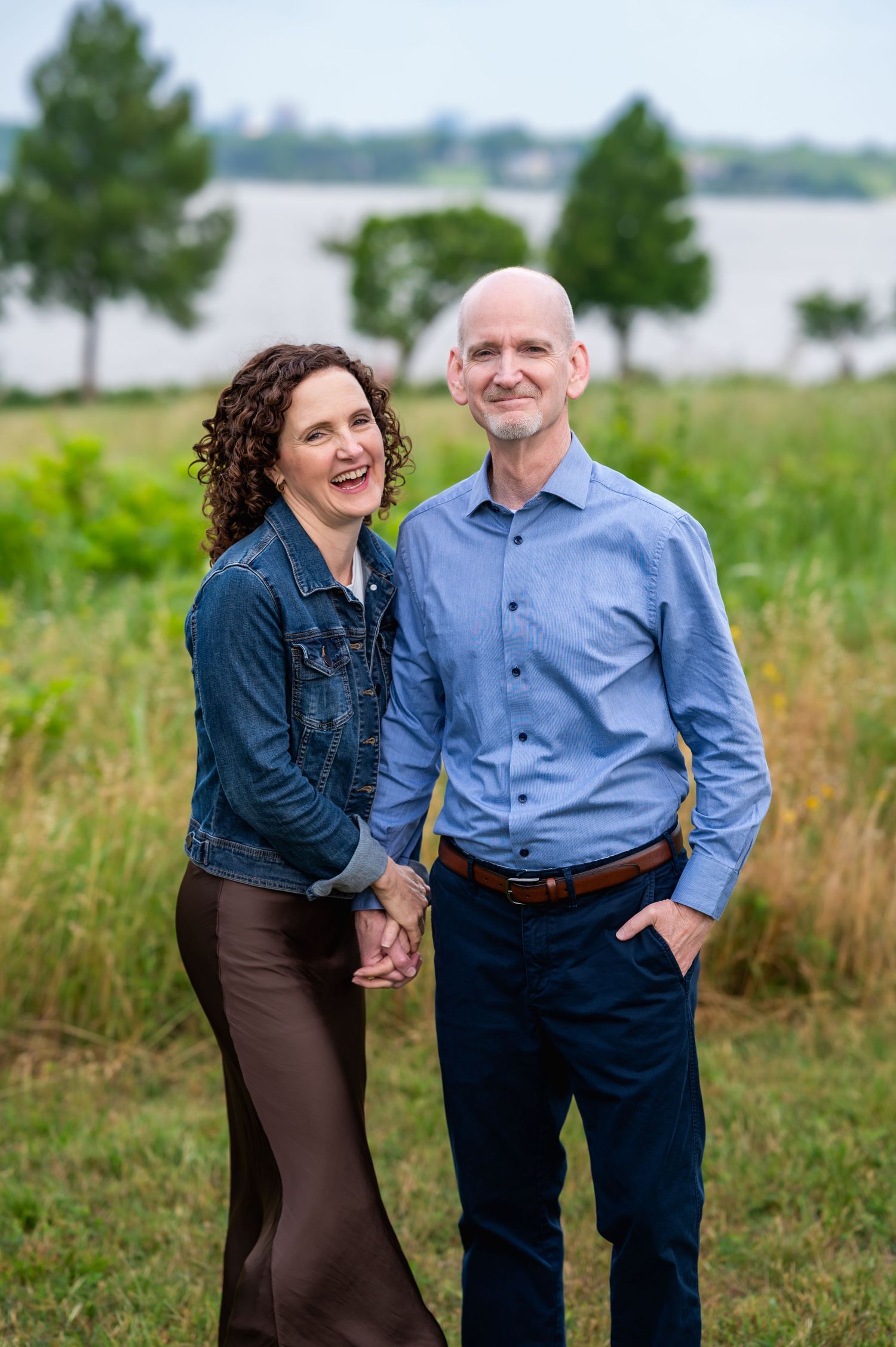 photo of mom and dad holding hands posing next to white rock lake in dallas by mesquite family photographer