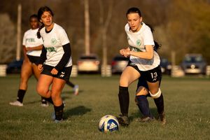 Soccer player dribbles the ball down the field during training session or practice.