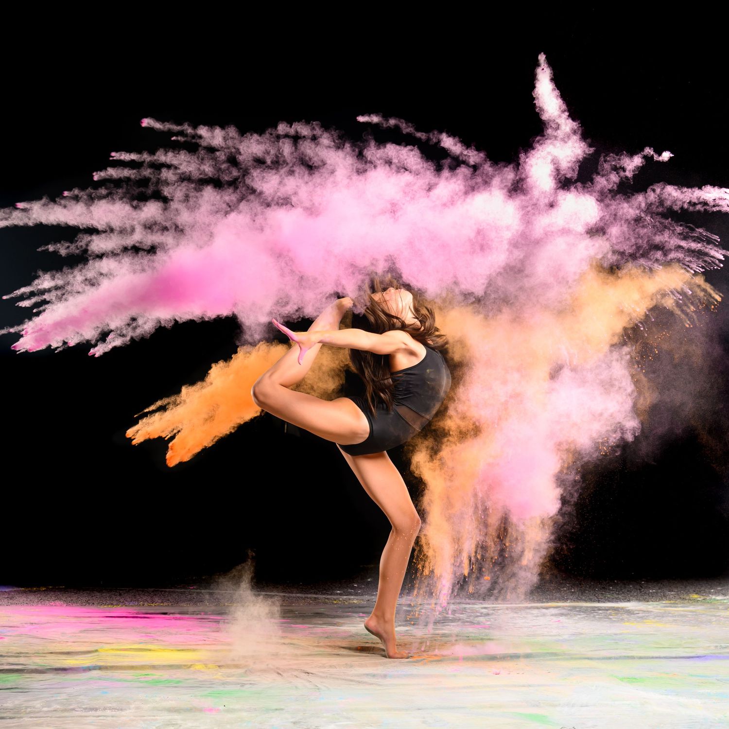 Dynamic dance movements with colorful powder effects creating artistic motion trails.