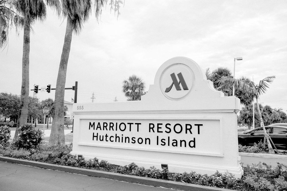 Entrance sign for Marriott Resort on Hutchinson Island with palm trees and landscaping in black and white.