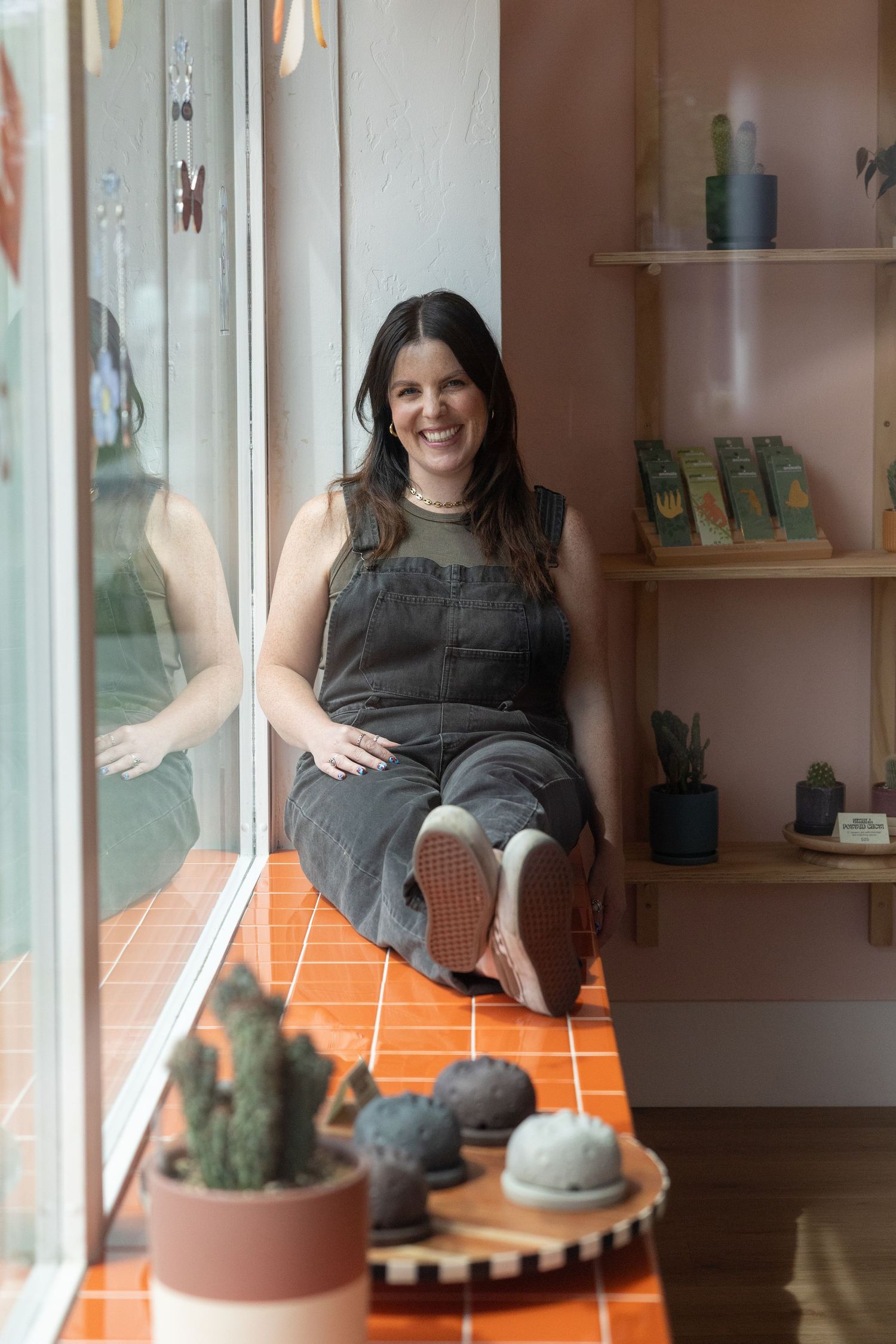 Shopkeeper Roxy at Easy Does It smiles in her self care shop.