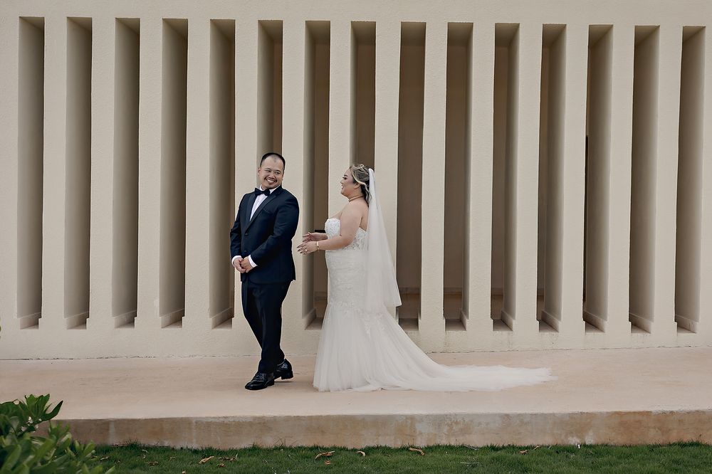 Bride and groom emotional during first look by modern wall structure at Hyatt Ziva Cancun.