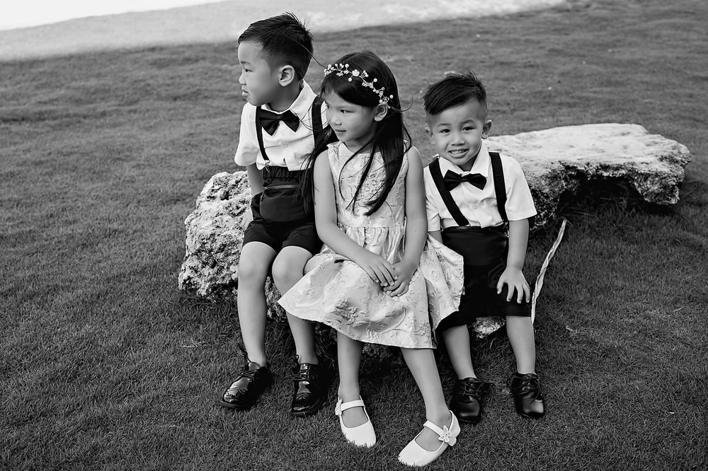 People kneeling on grass seen from above in black and white film format creating a dynamic line composition.