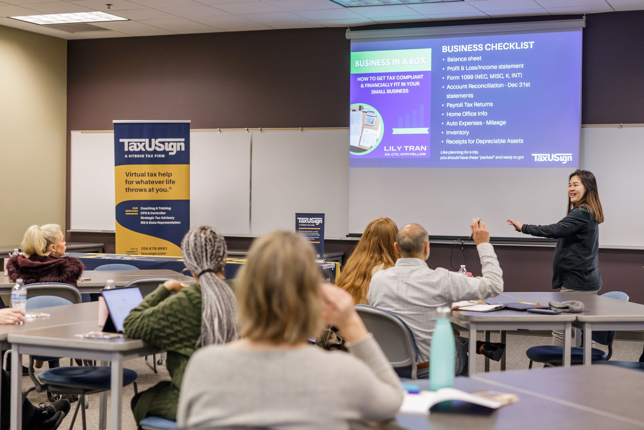 tax USign workshop in Kent, WA for business owners woman presenting in front of group in conference room