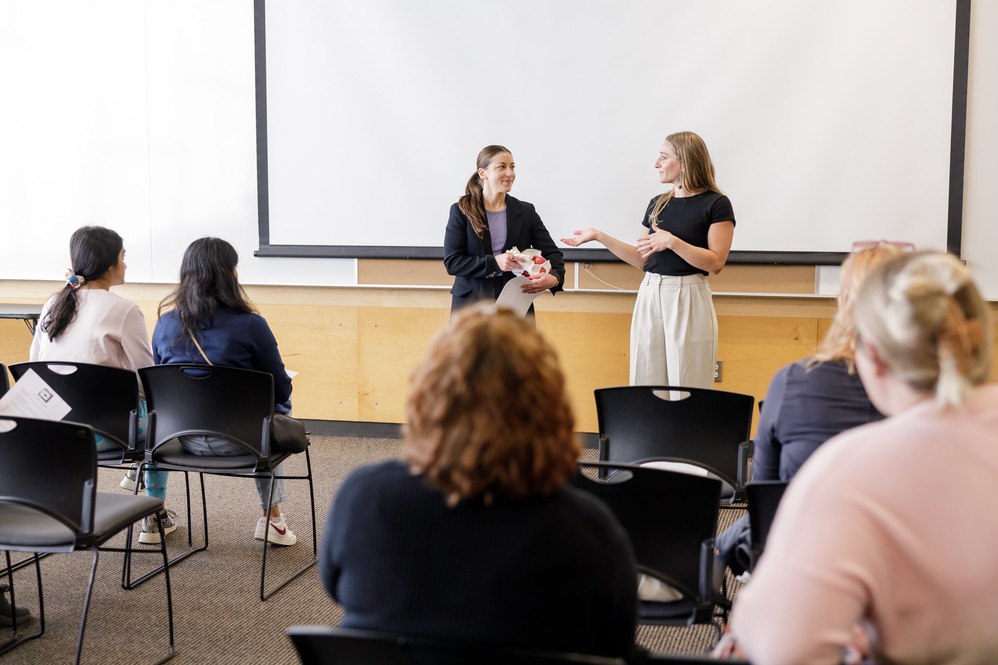 women chiropractors on Mercer Island class presentation about pelvic floor to group of women lifestyle event
