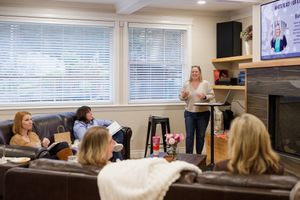 woman productivity business coach for business owners planning workshop woman presenting standing in front of group teach learning