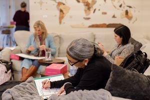 woman productivity business coach for business owners planning workshop working taking notes learning while woman presents