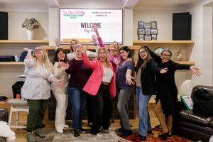 woman productivity business coach for business owners planning workshop group of attendees and presenter standing together group celebration