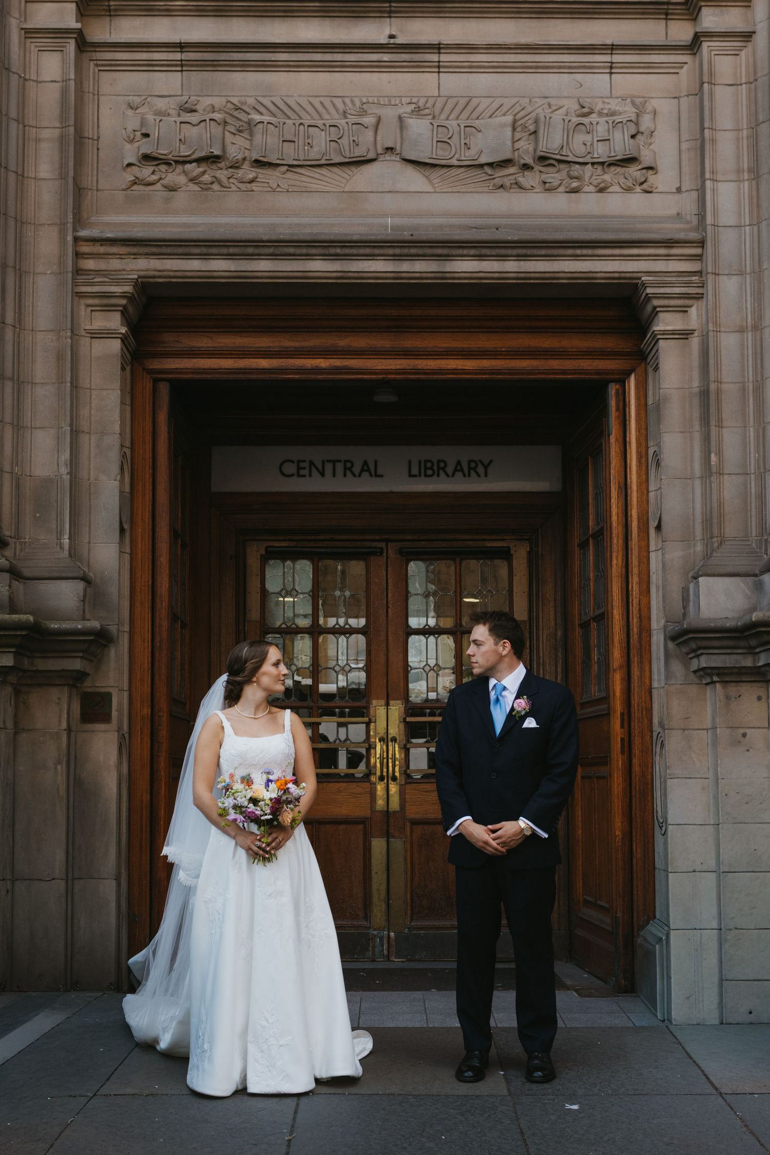 Wedding ceremony in a historic stone church with gothic arched windows.