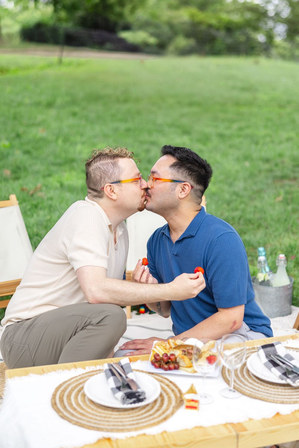 Romantic outdoor picnic with table settings and drinks in Central Park set up for a surprise proposal in NYC.