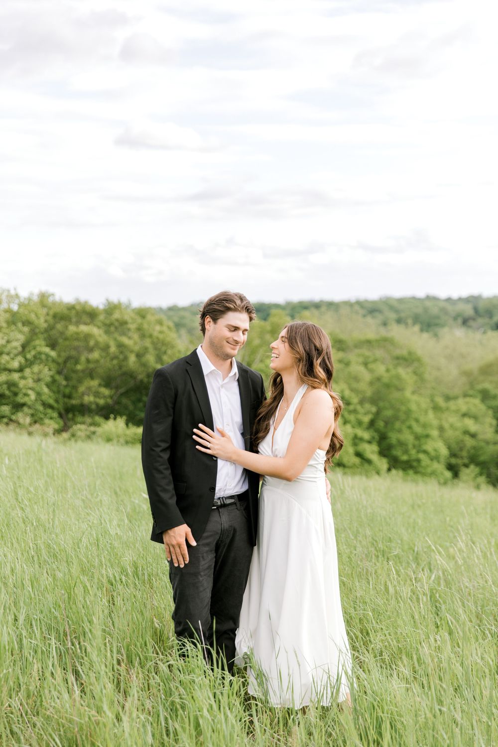 Engaged couple in the tall grass at Natirar Park in Peapack, NJ.