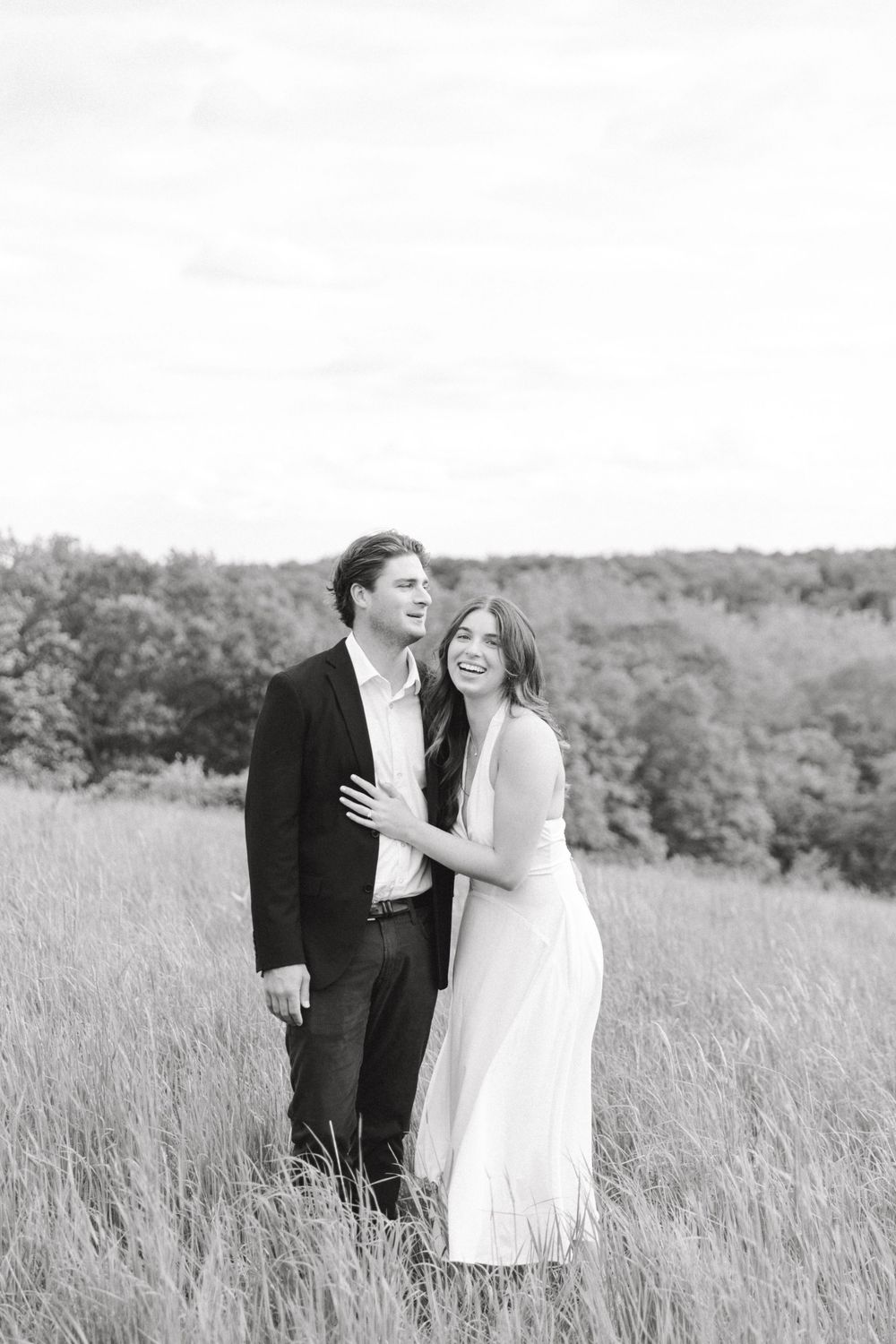 Engaged couple in the tall grass at Natirar Park in Peapack, NJ.