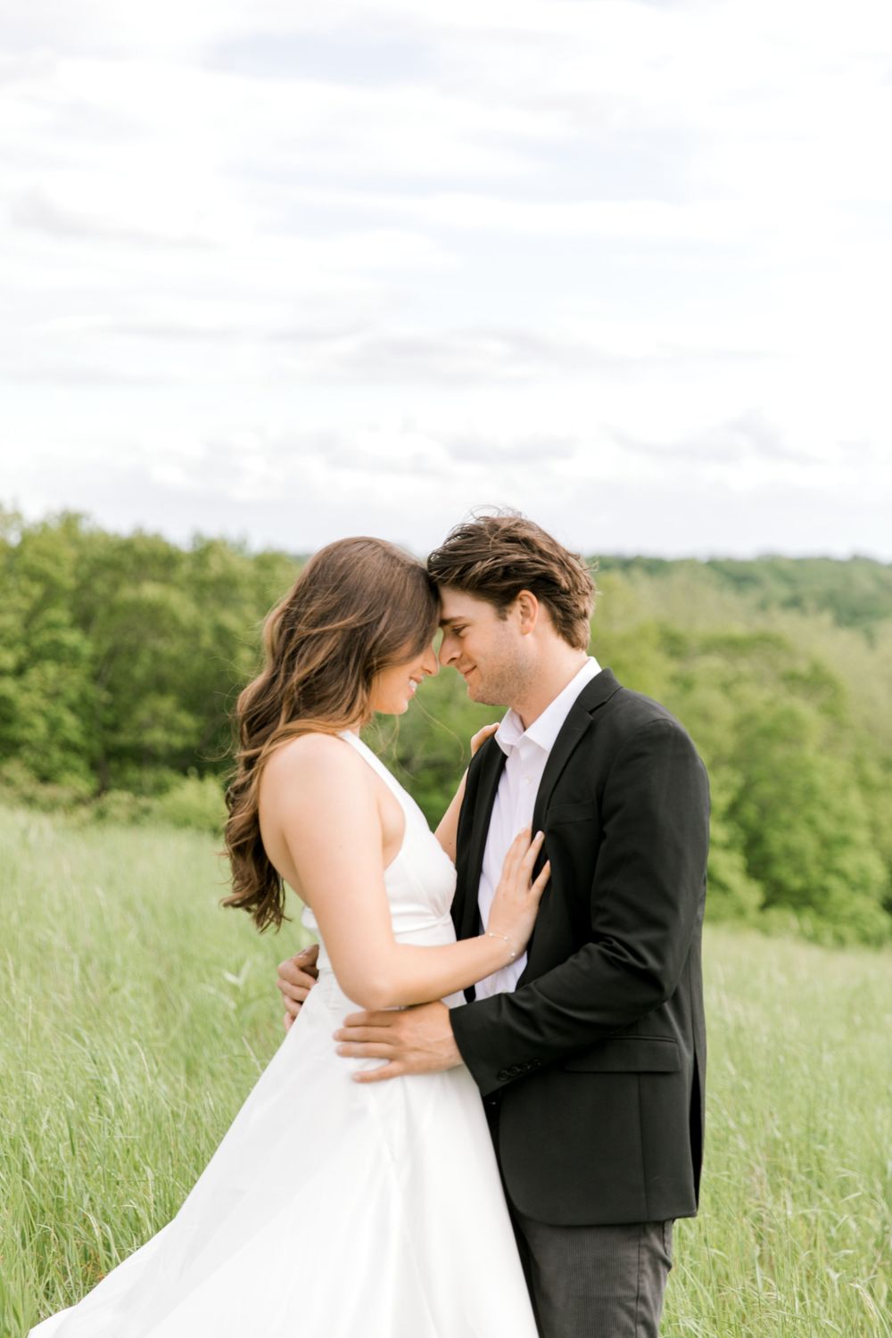 Engaged couple in the tall grass at Natirar Park in Peapack, NJ.