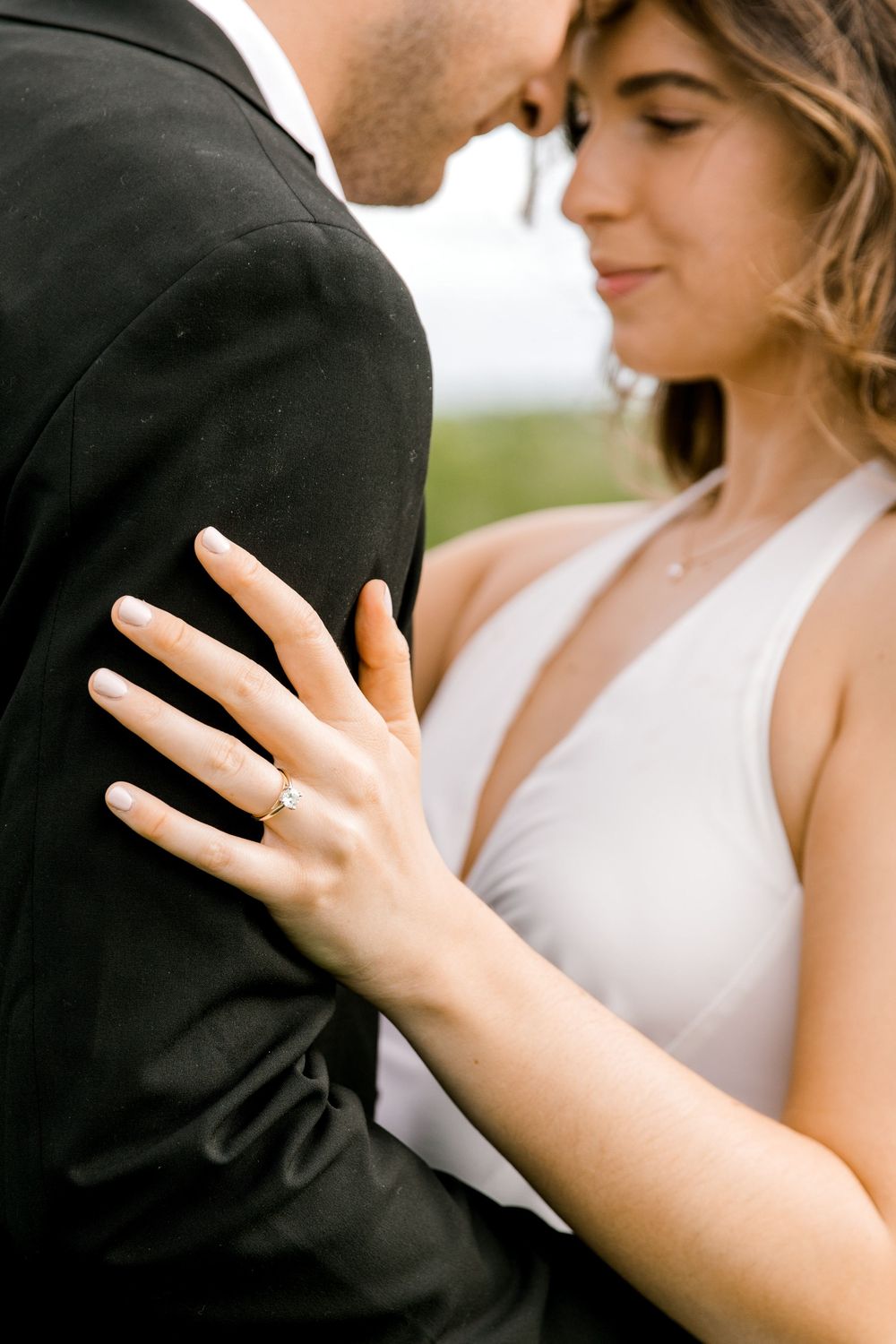 Engaged couple in the tall grass at Natirar Park in Peapack, NJ.
