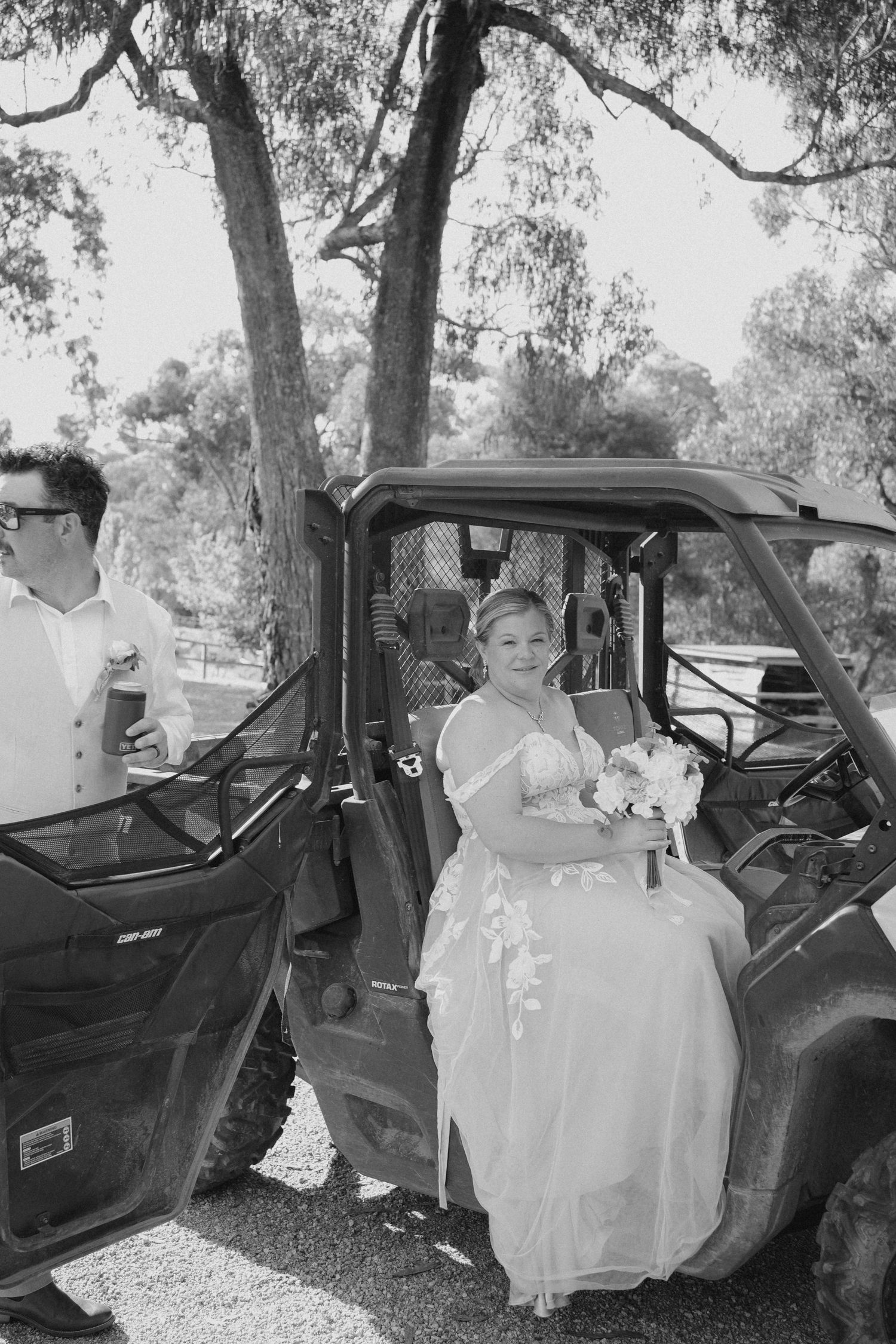 Wedding day transportation in a utility vehicle decorated for the special occasion in a natural outdoor setting.