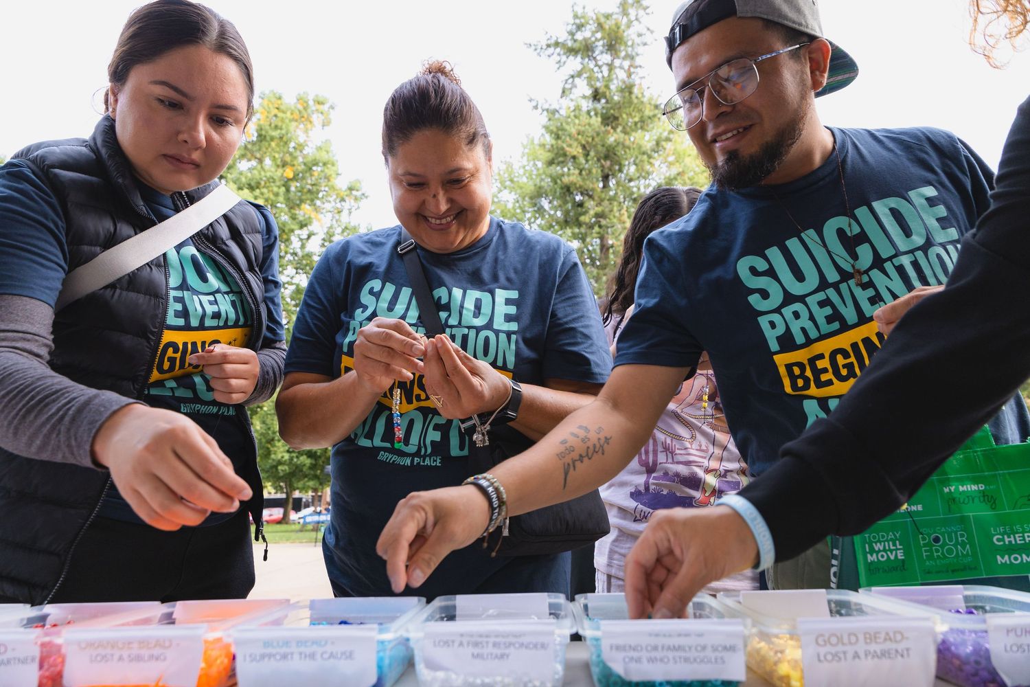 People making bracelets at Gryphon Place Suicide Prevention Walk in Kalamazoo