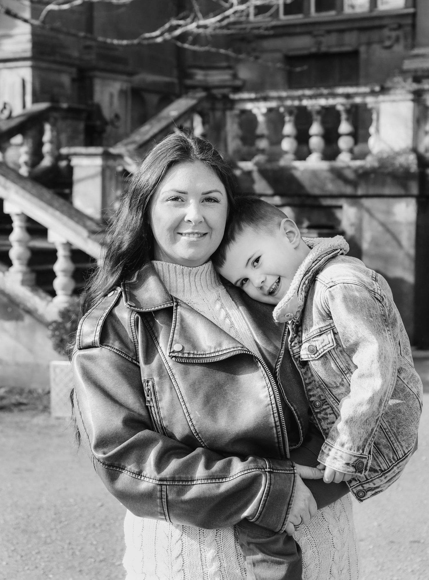 A black and white intimate portrait showing a sweet maternal moment between mum and son during family shoot in Nottingham