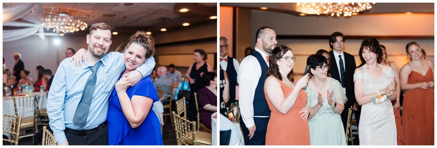 Wedding guests dancing and celebrating together on a ballroom dance floor at a reception with warm lighting and chandeliers.