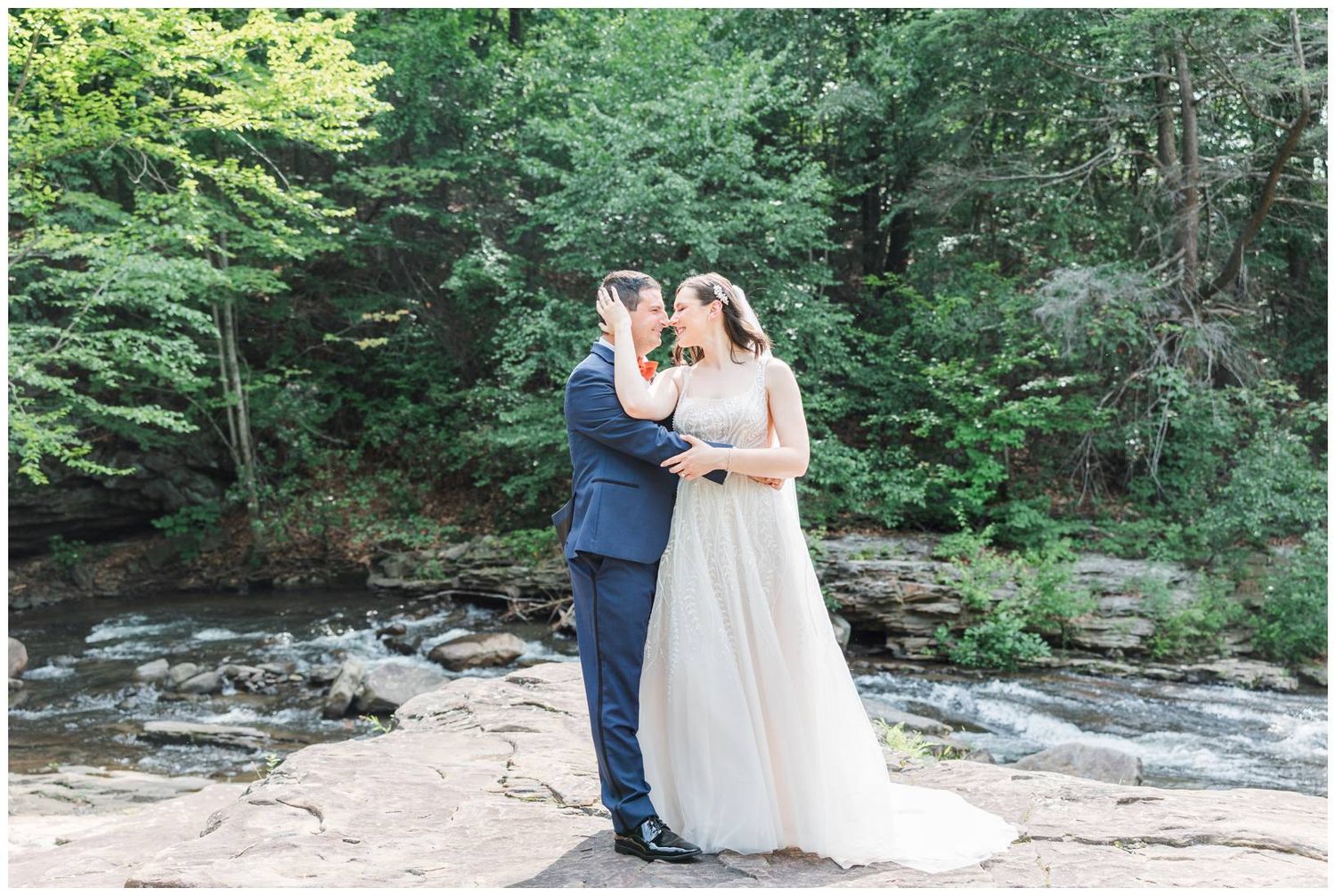 Outdoor wedding portraits in a lush green forest setting during summer.