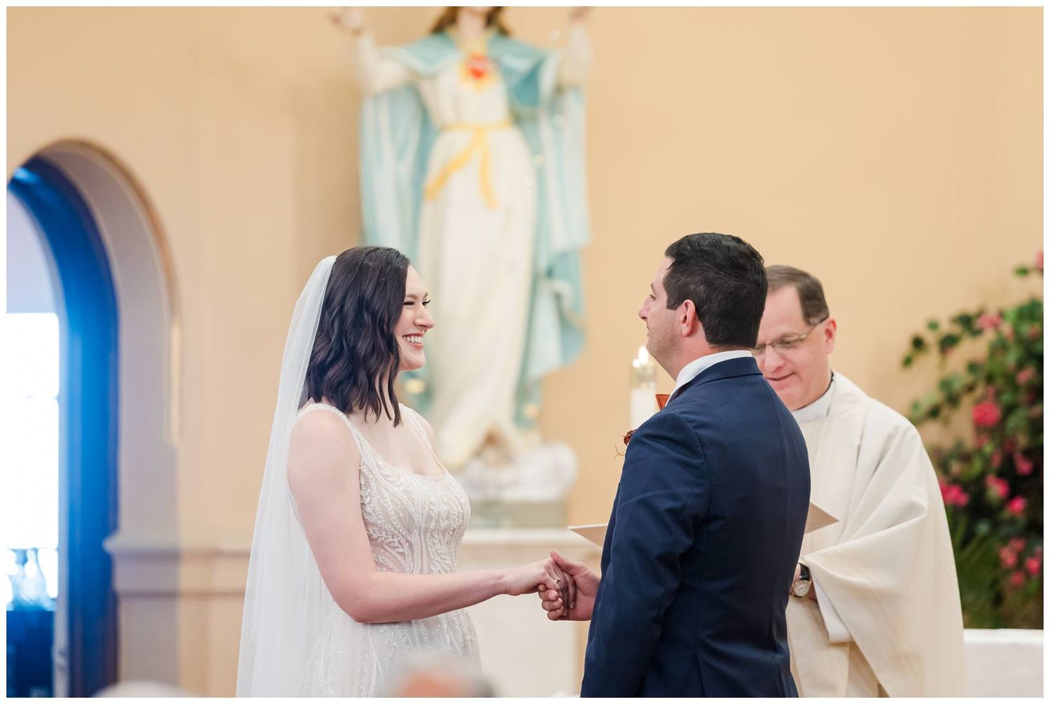 Traditional church wedding ceremony with natural light streaming through windows.