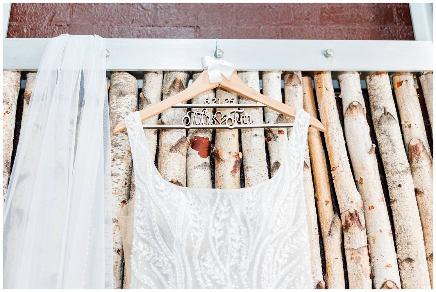 Rustic wedding decor features elegant white birch branches arranged against a wall creating a natural backdrop.