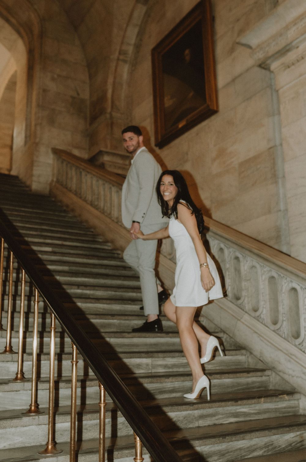 Artistic sequence of engagement photos captured on historic marble steps with romantic lighting.