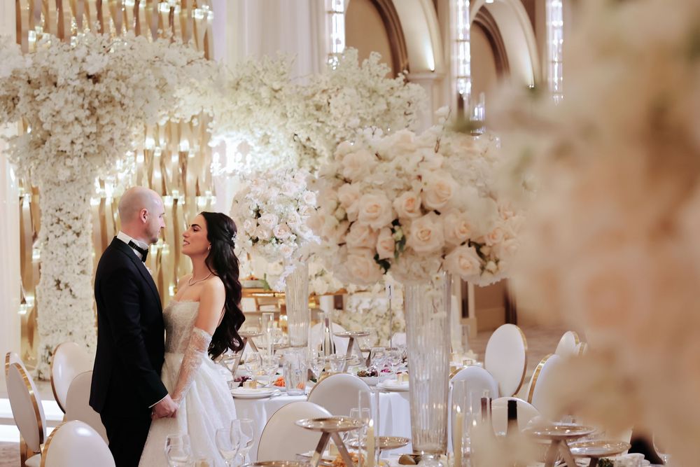 Elegant wedding venue decorated with crystal chandeliers and white floral arrangements for an intimate celebration.