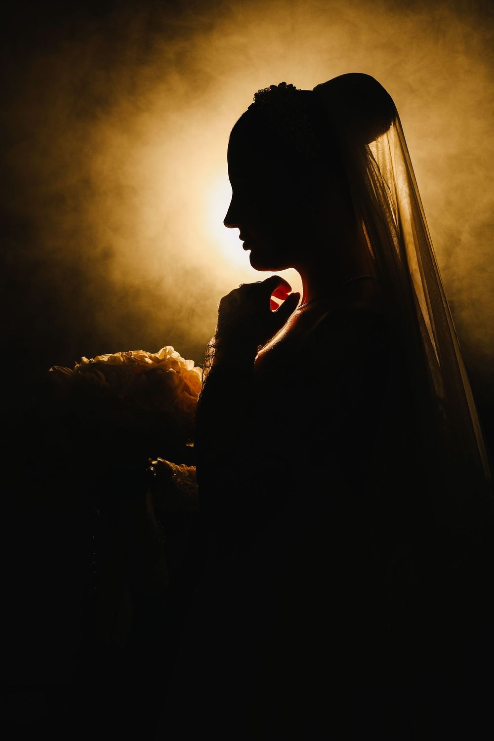 Artistic dark silhouette portraits with dramatic golden backlighting create a moody atmospheric series.