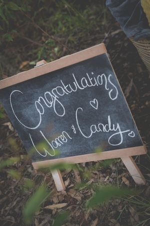 a chalkboard with congradulations written to Warren & Candy with a heart