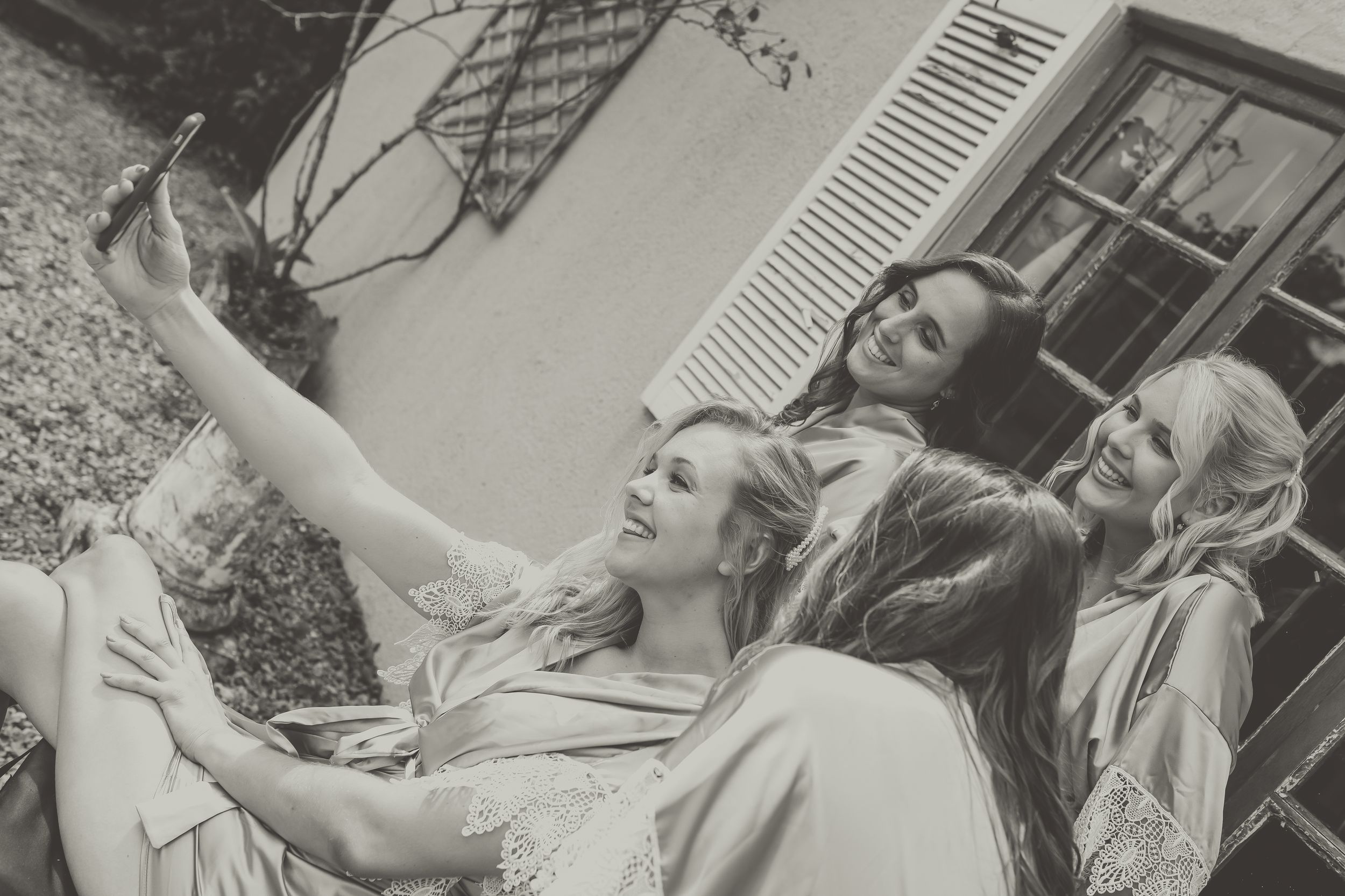 A bridal party in the dressing gowns taking a selfie