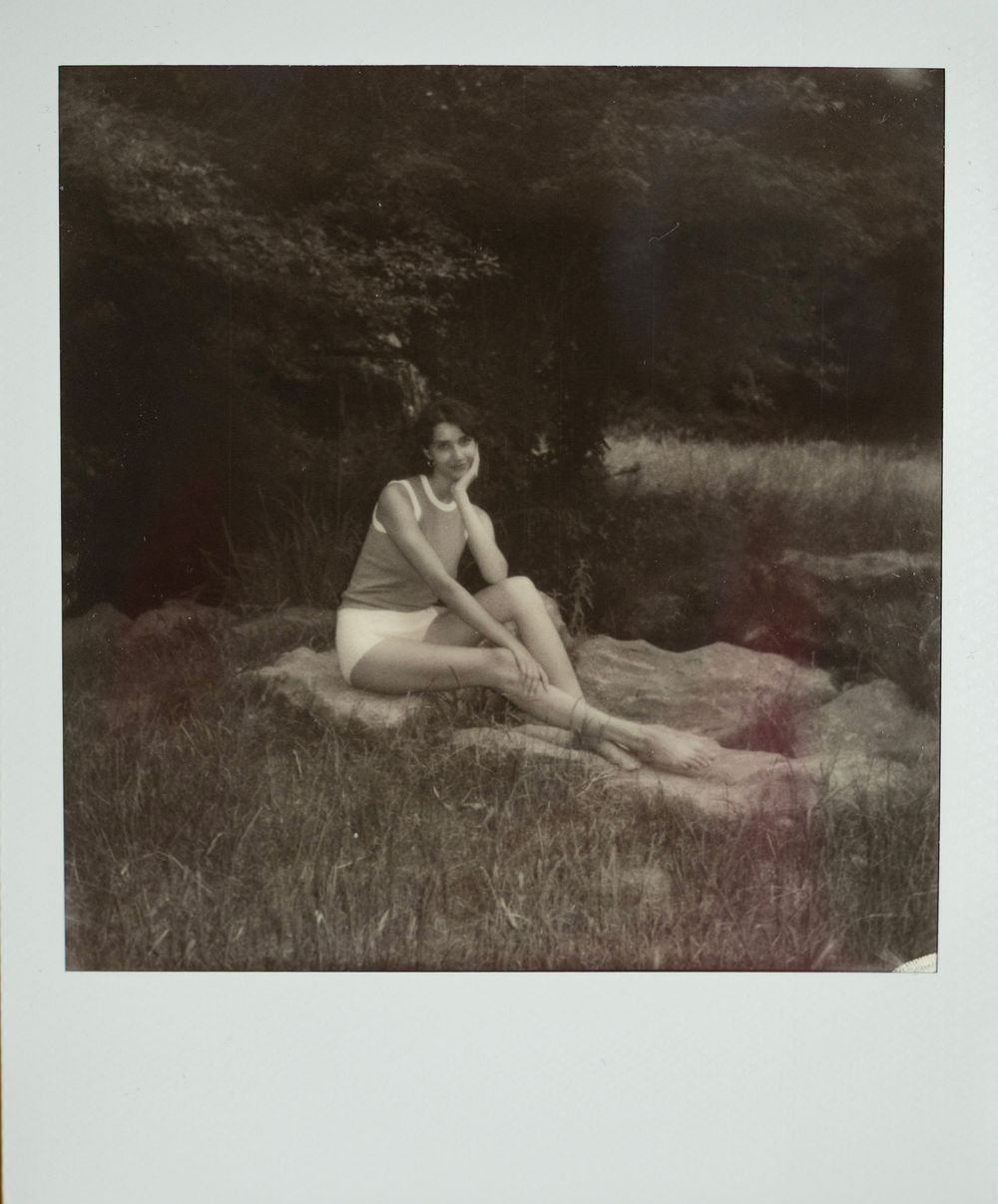 A series of vintage sepia photographs showing a figure reclining in nature on grassy ground.