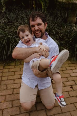 Playful series showing joyful interactions and laughter on a brick wall backdrop.