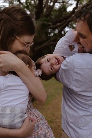 Intimate sequence showing loving family interactions and embraces in a natural setting.