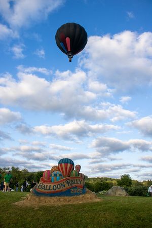 Panoramic view of balloon rally sand sculpture with hot air balloons taking off.