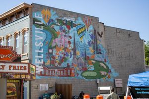 Colorful street art murals decorate the exterior walls of downtown buildings.