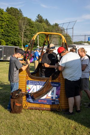 Festival attendees browsing vendor booths and displays at an outdoor community event.