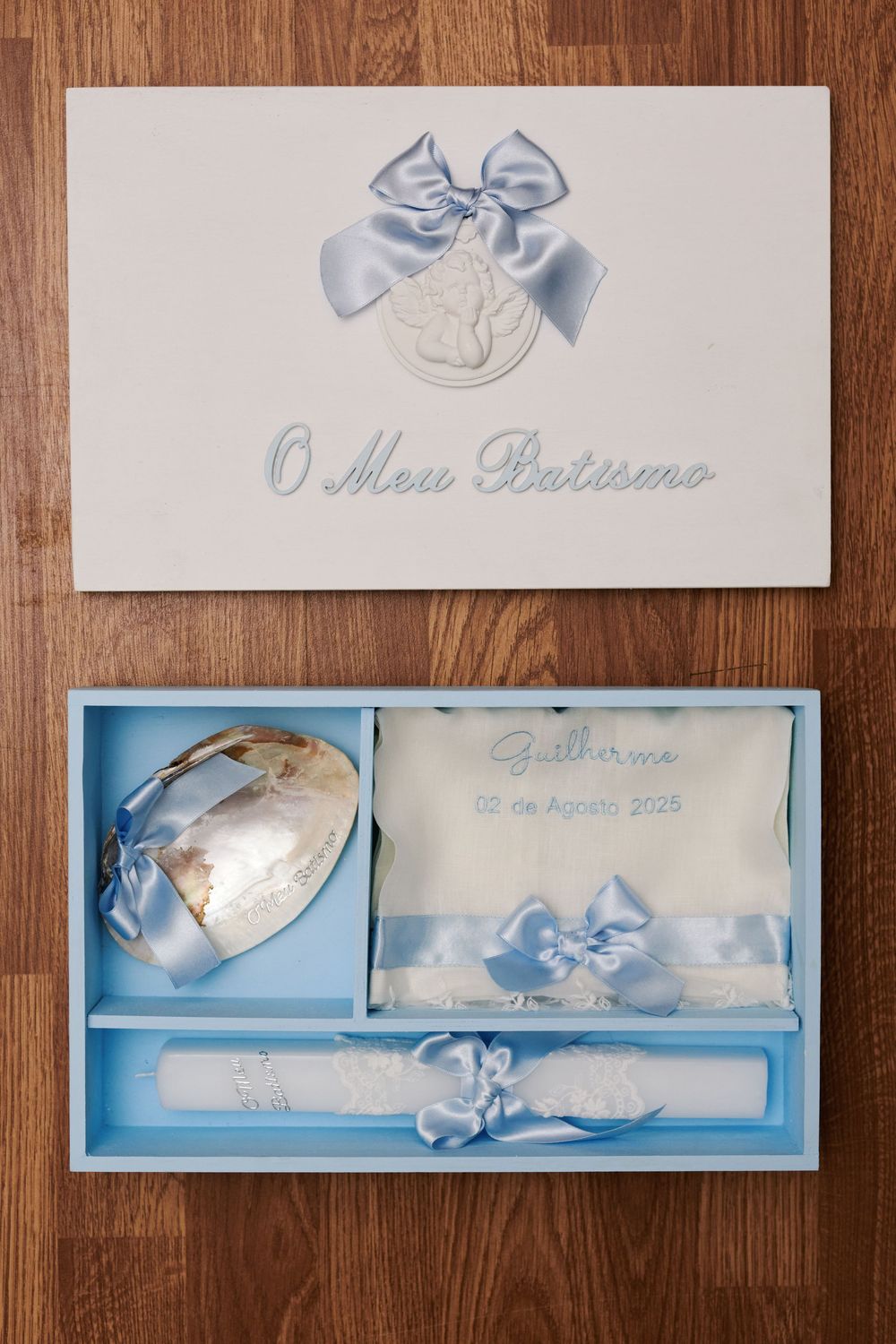 Portuguese baptism keepsake box O Meu Batismo with blue ribbon bow, shell, candle, and embroidered cloth for Guilherme.