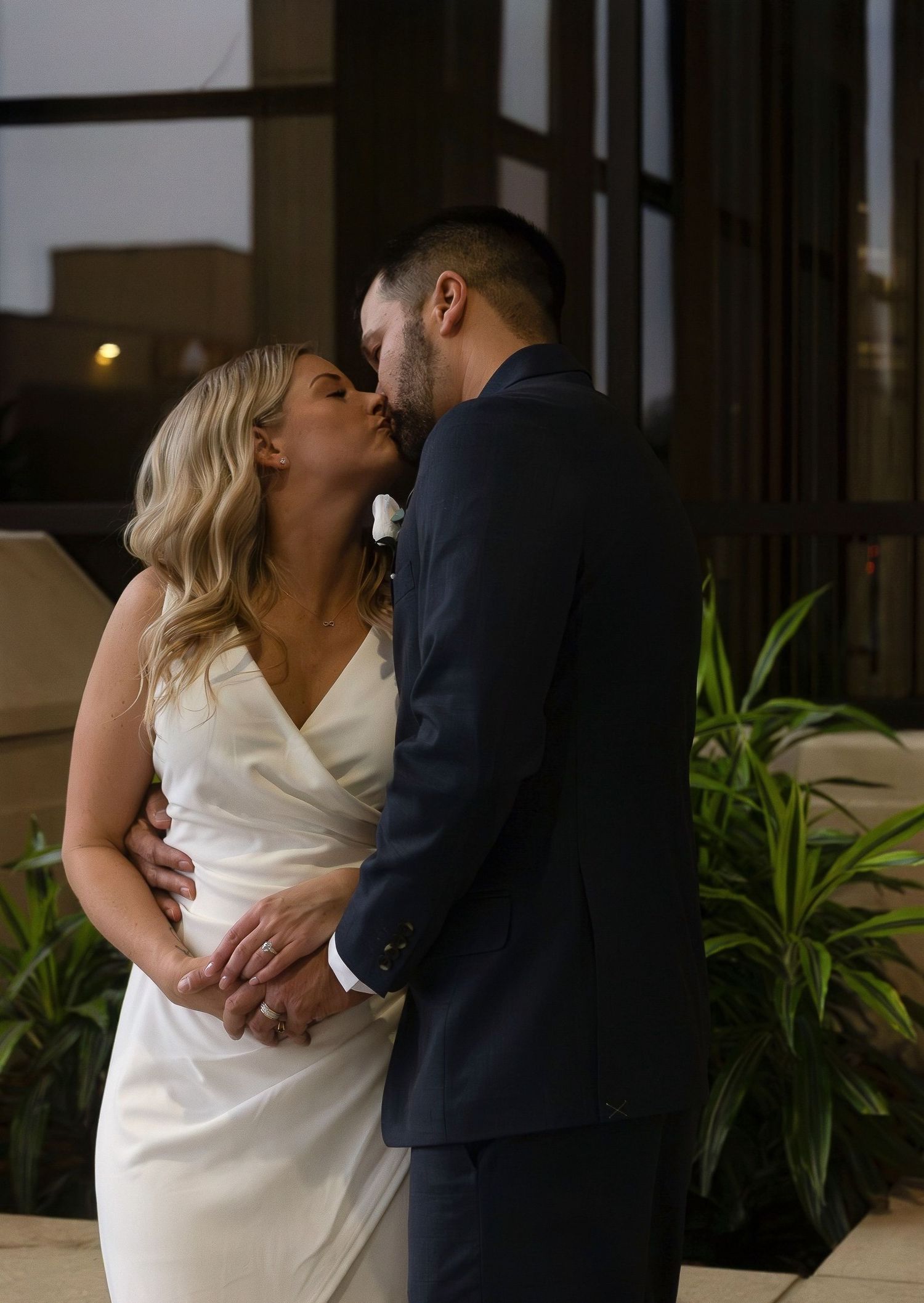Romantic evening portrait of couple in wedding attire sharing an intimate moment.