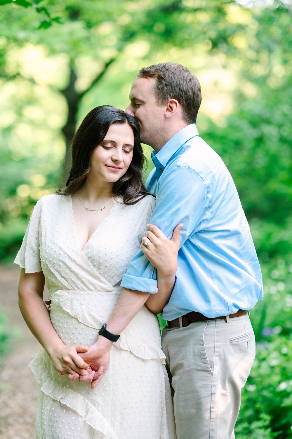 A tender moment captured between a couple in a spring garden setting.