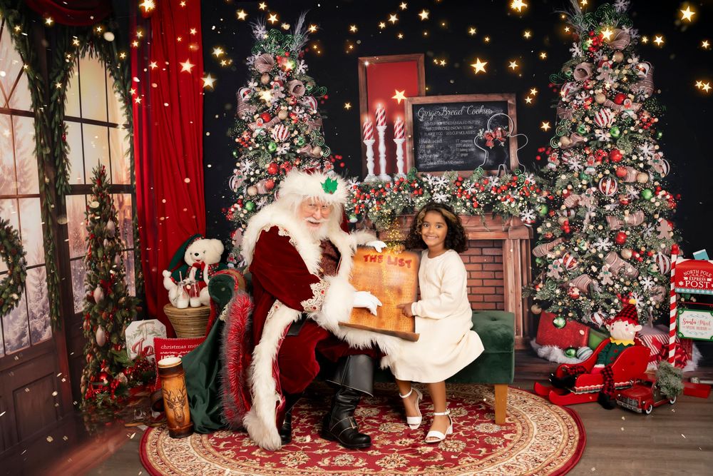 A festive holiday scene featuring decorated Christmas trees, red walls, and Santa's chair with sparkling lights and ornaments.