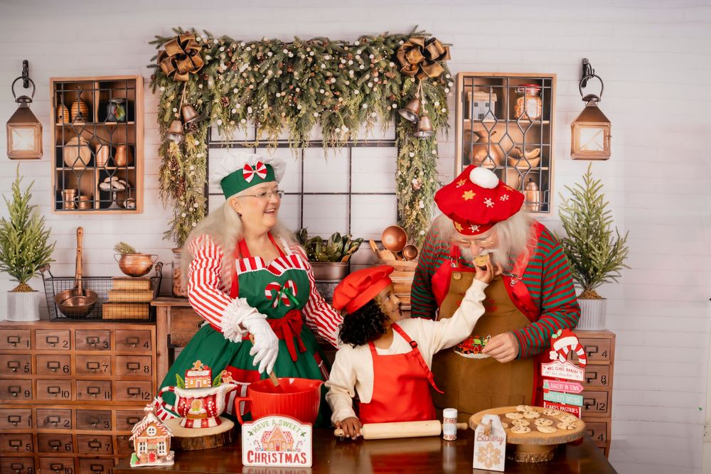 Christmas antique toys and decor displayed in a festive rustic workshop setting with Santa figures and holiday greenery.